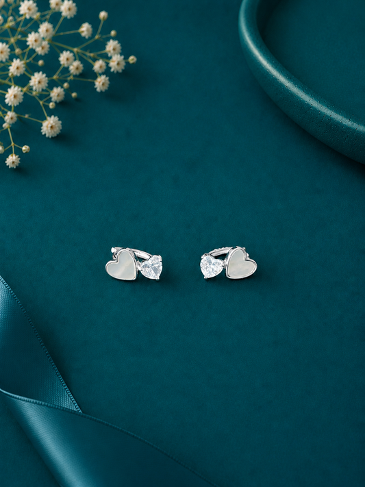 Elegant sterling silver heart stud earrings with sparkling crystal drops, perfect for adding a touch of charm to your everyday style.